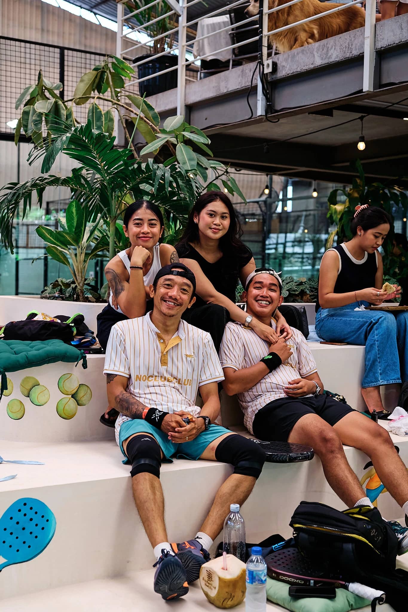 Players sitting together on the tribune between matches at Bam Bam Padel