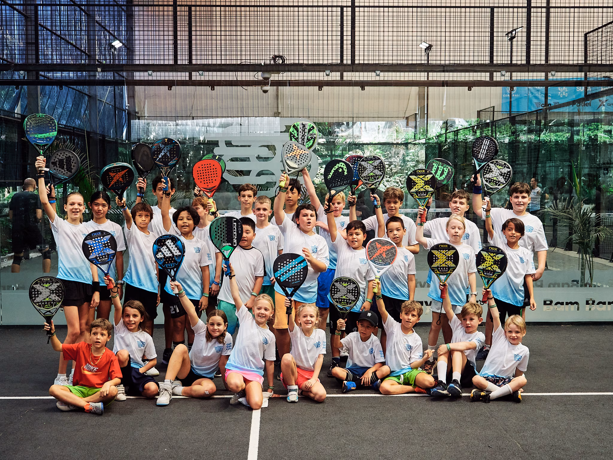Children from the kids academy on court with their rackets