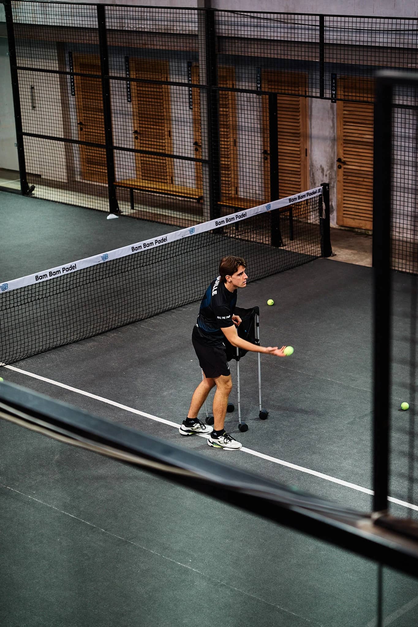 A player mid-rally on a covered court