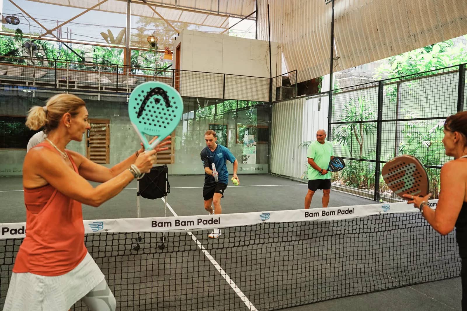 Adult players at the net during a clinic