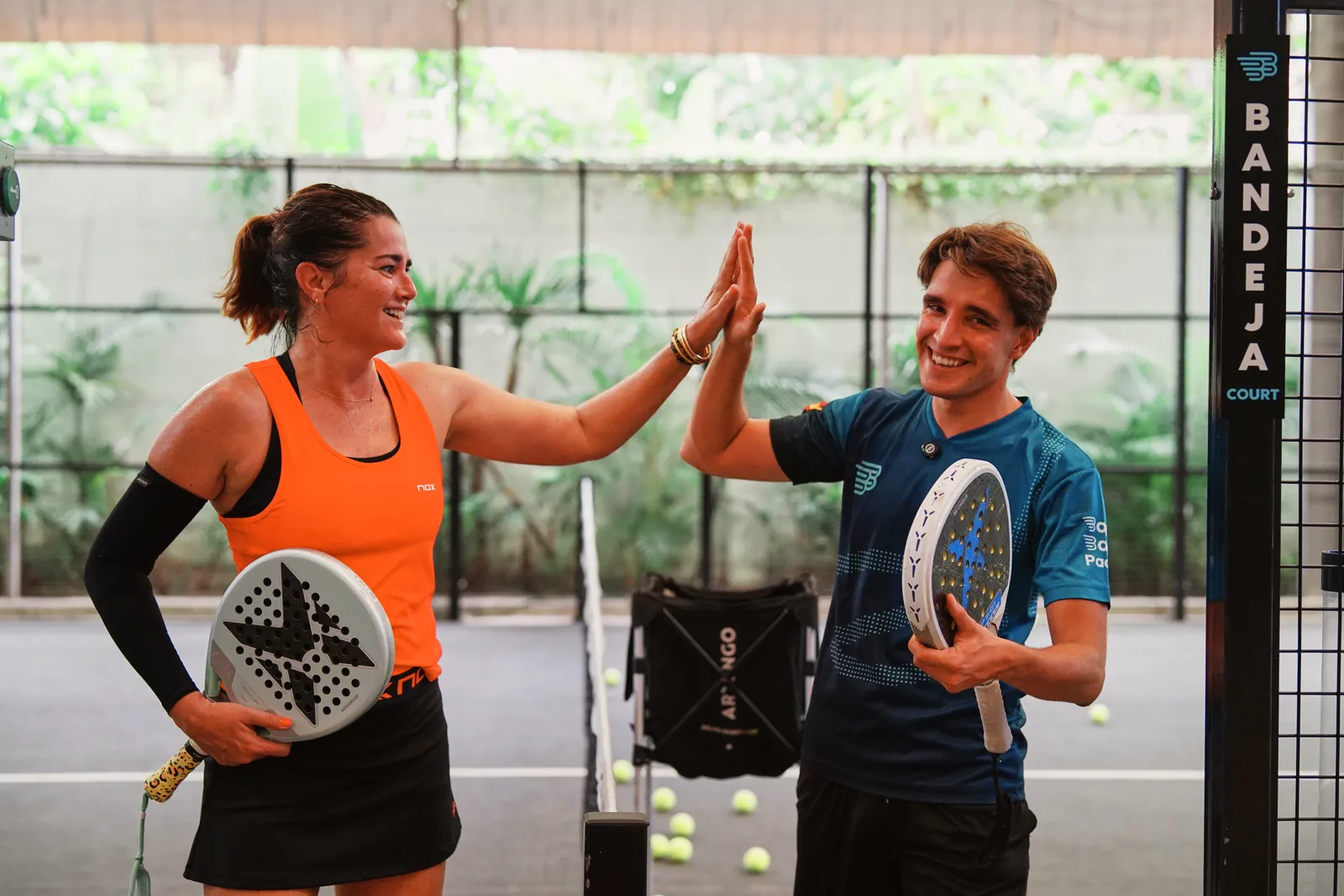 Coach Guille high-fiving a student on court